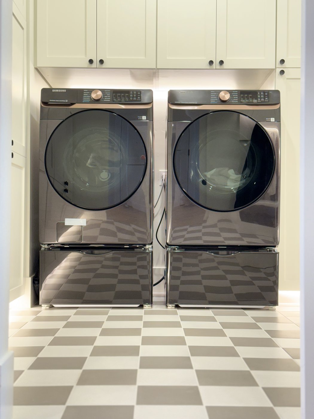 Spotless laundry room with washer dryer and checkered floor — Move-In ready by ChicProClean
